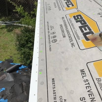 Roofing underlayment installation with SPEC brand materials on a house.