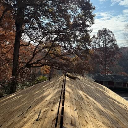 View from a wooden dock surrounded by autumn foliage and a serene lake.