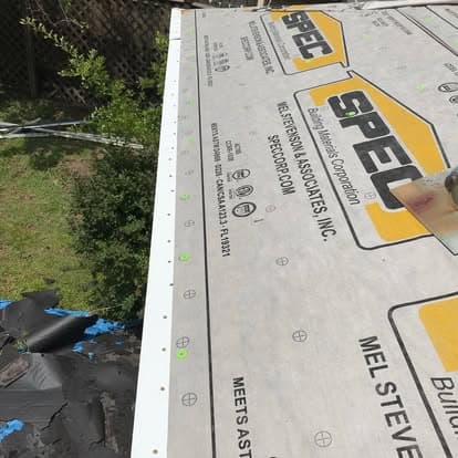 Roof underlayment installation with SPEC brand waterproofing material in progress.